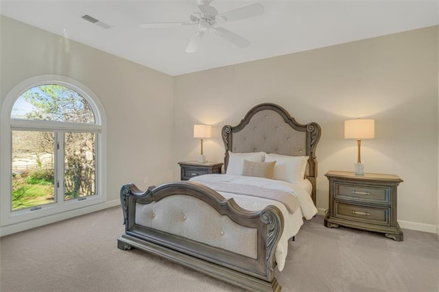 carpeted bedroom with a ceiling fan, visible vents, and baseboards