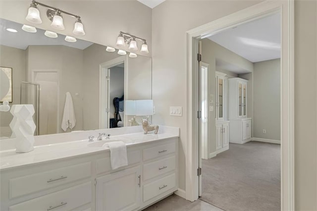 bathroom with baseboards and vanity