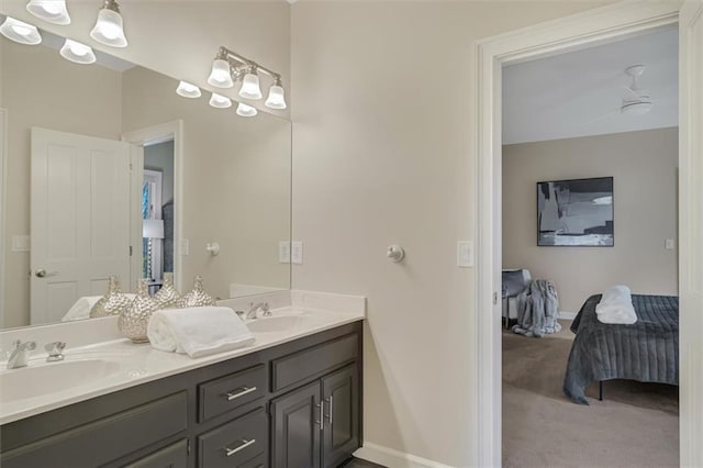 full bathroom featuring a sink, double vanity, ceiling fan, and connected bathroom