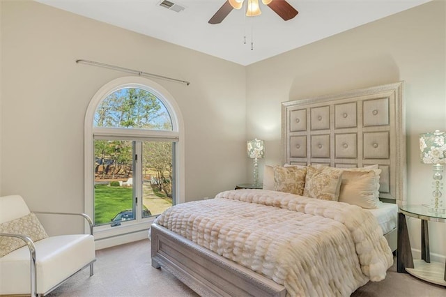 bedroom featuring visible vents, a ceiling fan, and light colored carpet