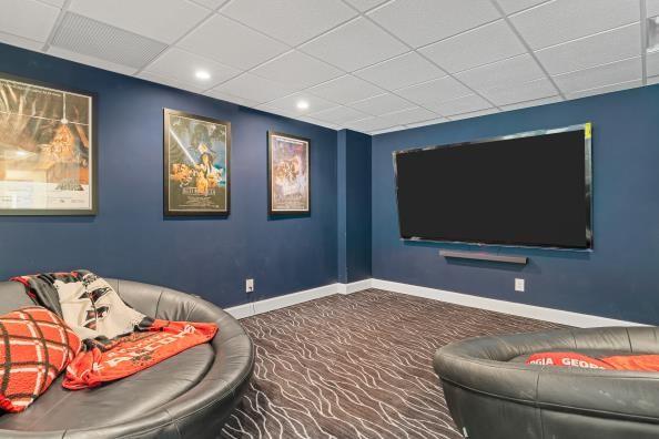 carpeted cinema room with baseboards, a drop ceiling, and recessed lighting