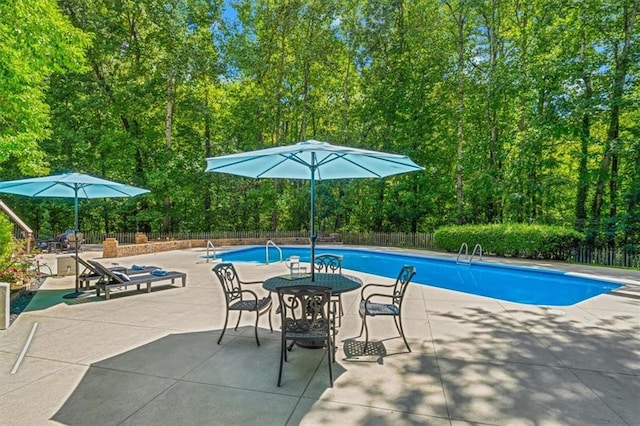 view of pool with a fenced in pool, a patio area, and fence