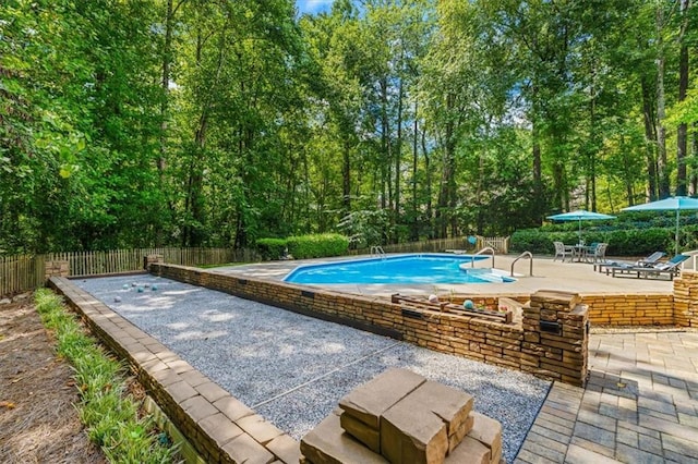 view of swimming pool with a patio area, fence, and a fenced in pool