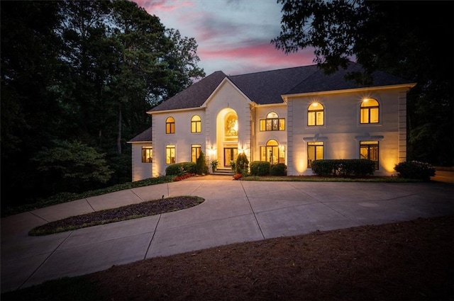 view of front facade with concrete driveway and stucco siding