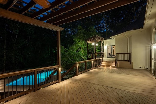 deck at twilight with an outdoor pool, a pergola, and french doors