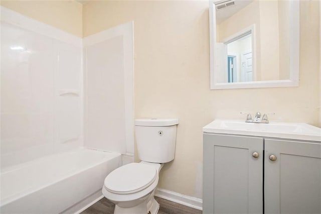 full bath featuring toilet, wood finished floors, vanity, visible vents, and baseboards