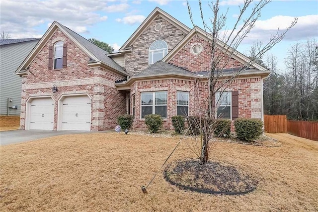 view of property featuring a garage and a front yard