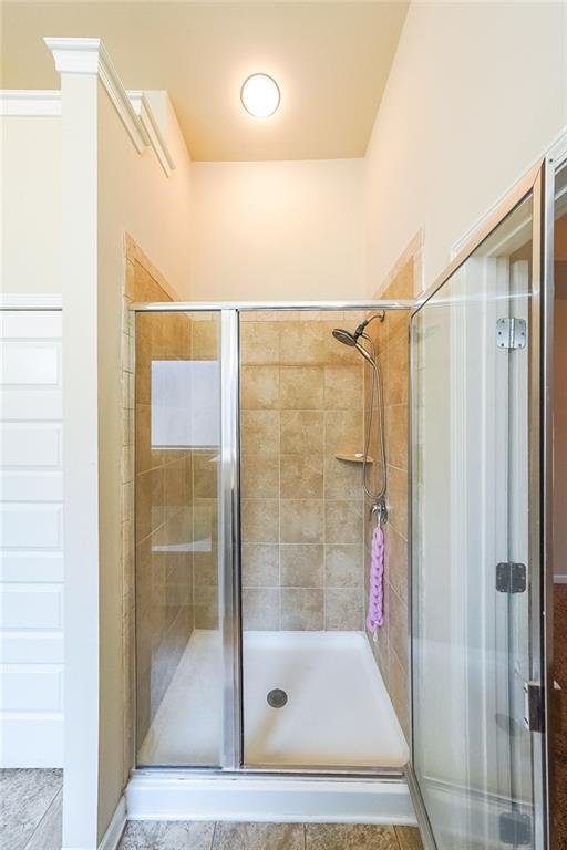 bathroom with a shower with shower door