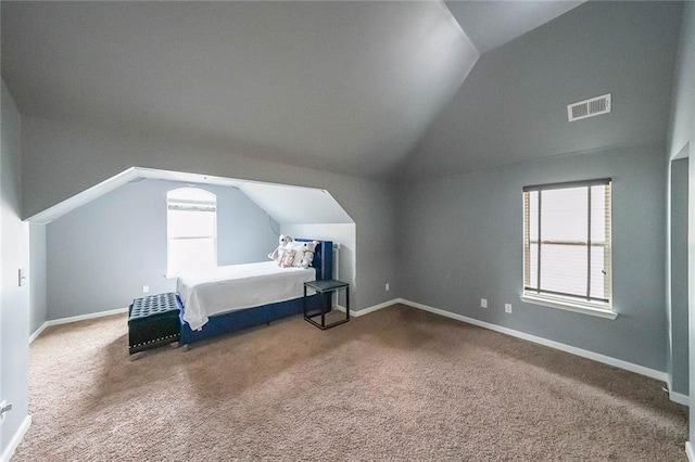 carpeted bedroom with vaulted ceiling