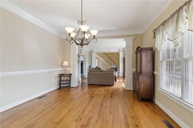 unfurnished living room with visible vents, crown molding, and ornate columns