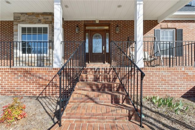 view of exterior entry with brick siding