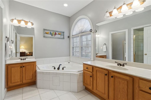 full bathroom with a sink, a bath, a shower stall, and tile patterned flooring