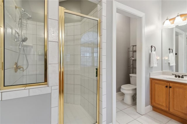 bathroom with toilet, a stall shower, tile patterned flooring, baseboards, and vanity