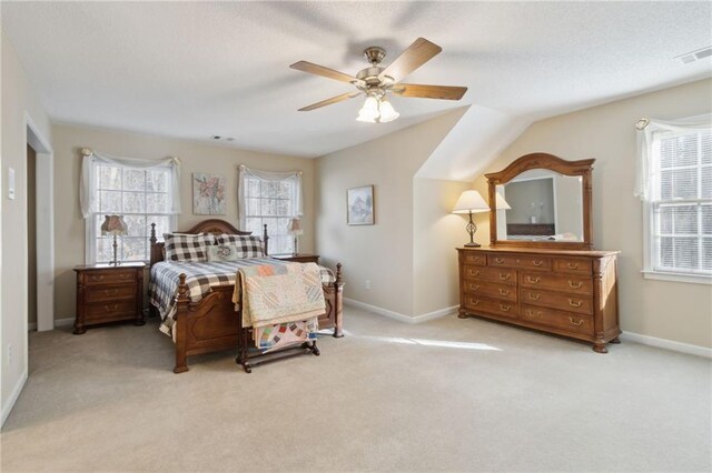 carpeted bedroom with visible vents, ceiling fan, a textured ceiling, and baseboards