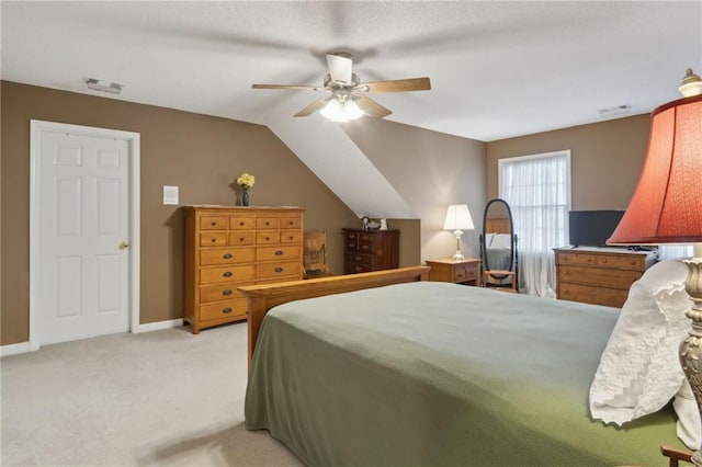 bedroom with visible vents, baseboards, lofted ceiling, light carpet, and a ceiling fan