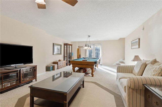 recreation room with a textured ceiling, billiards, a ceiling fan, and light carpet