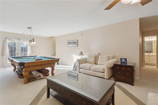 recreation room with light carpet, a textured ceiling, and pool table