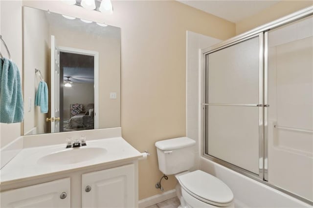 ensuite bathroom featuring toilet, ensuite bath, vanity, and shower / bath combination with glass door