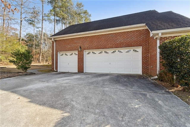 garage featuring concrete driveway