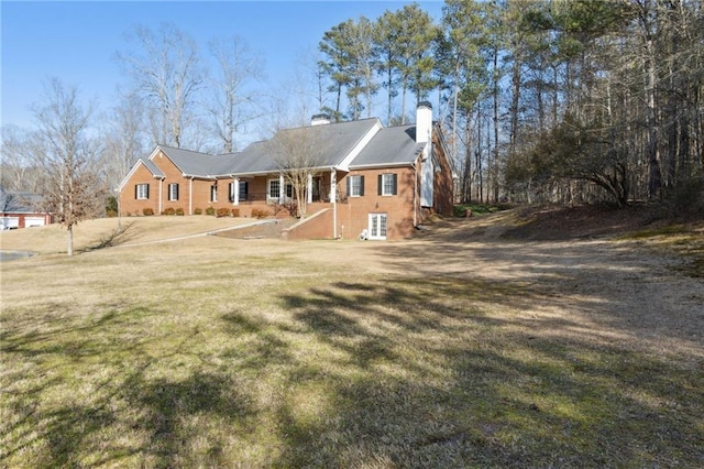 view of front of home with a front yard and a chimney