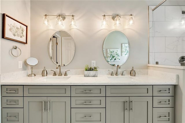 full bath with double vanity and a tile shower