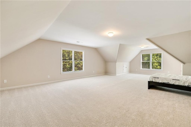 unfurnished bedroom with vaulted ceiling, carpet, and baseboards