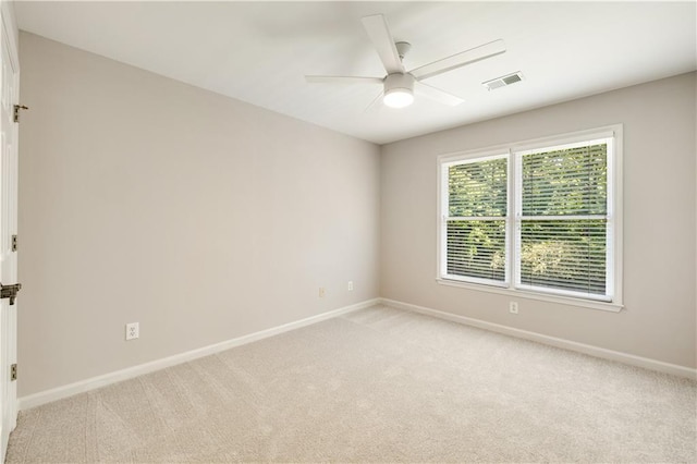 empty room with light carpet, baseboards, and a ceiling fan