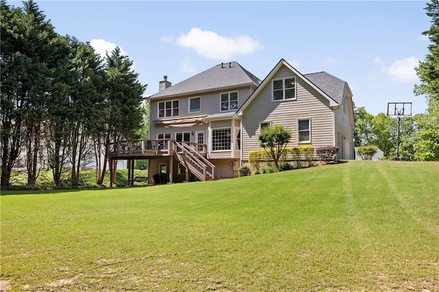 rear view of property with stairs, a deck, a chimney, and a yard