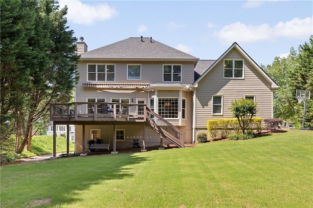back of property with a wooden deck, stairway, a chimney, and a lawn