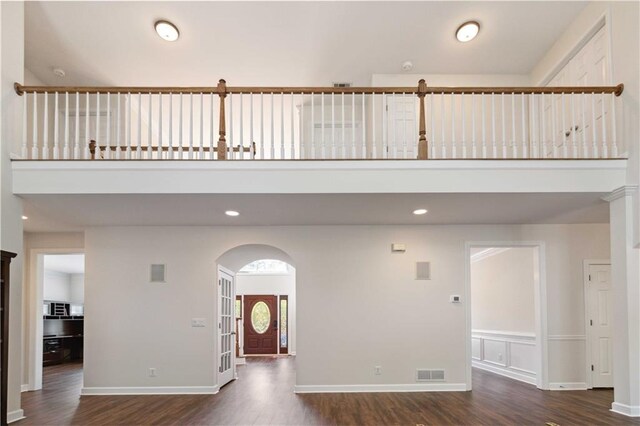 5073 Kingsbridge Pass, Powder Springs, GA 30127 - foyer with recessed lighting, a high ceiling, visible vents, arched walkways, and dark wood-style flooring