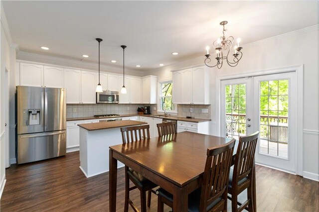 5073 Kingsbridge Pass, Powder Springs, GA 30127 - dining room featuring recessed lighting, dark wood-style floors, french doors, crown molding, and a notable chandelier
