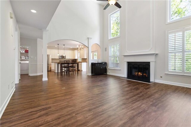 5073 Kingsbridge Pass, Powder Springs, GA 30127 - living room featuring a high ceiling, ceiling fan with notable chandelier, and plenty of natural light