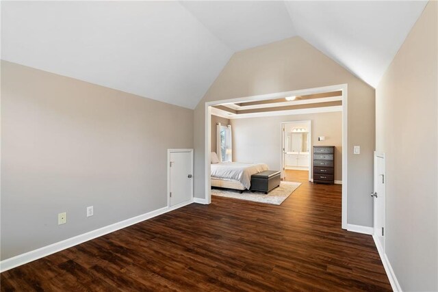 5073 Kingsbridge Pass, Powder Springs, GA 30127 - unfurnished bedroom featuring ensuite bath, vaulted ceiling, baseboards, and dark wood finished floors