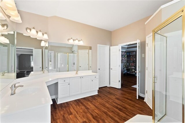 5073 Kingsbridge Pass, Powder Springs, GA 30127 - bathroom with a walk in closet, vanity, wood finished floors, and a stall shower