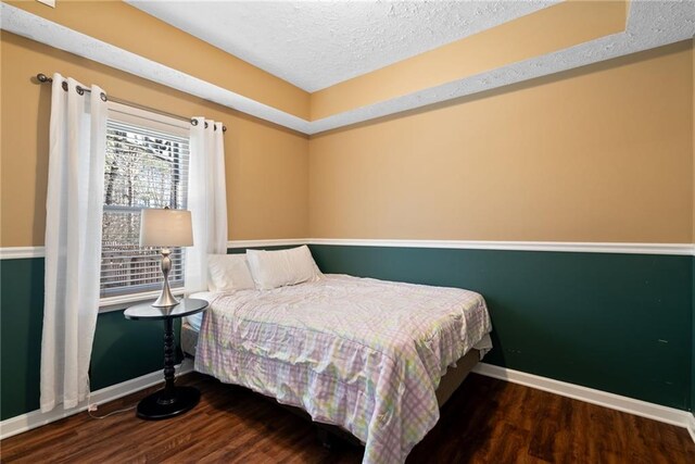 5073 Kingsbridge Pass, Powder Springs, GA 30127 - bedroom featuring wood finished floors, a textured ceiling, and baseboards