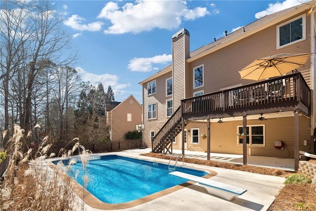 5073 Kingsbridge Pass, Powder Springs, GA 30127 - view of pool featuring a fenced in pool, fence, a wooden deck, a diving board, and a patio