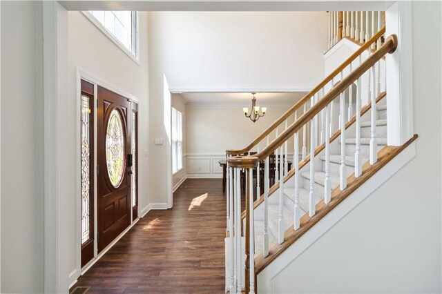 5073 Kingsbridge Pass, Powder Springs, GA 30127 - foyer featuring a wainscoted wall, dark wood-style floors, baseboards, an inviting chandelier, and stairway
