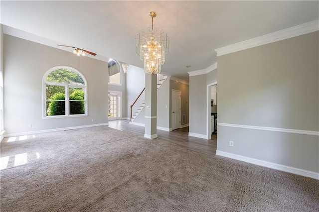 unfurnished living room with baseboards, stairway, ceiling fan with notable chandelier, and carpet floors