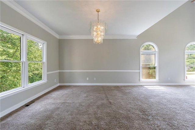 empty room with ornamental molding, carpet flooring, a chandelier, and baseboards