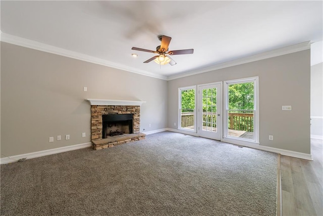 unfurnished living room featuring ceiling fan, light wood-style floors, baseboards, ornamental molding, and a fireplace