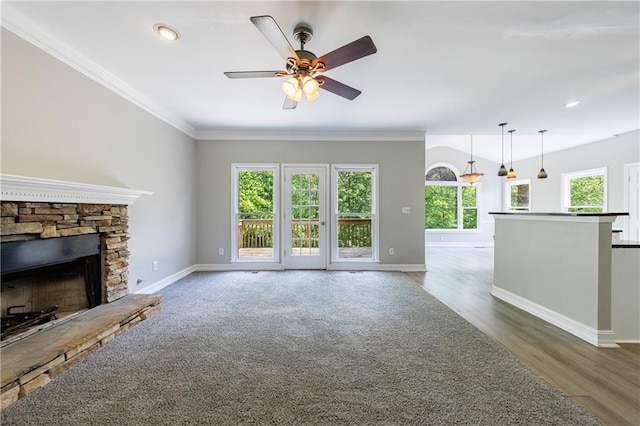 unfurnished living room featuring recessed lighting, ceiling fan, a stone fireplace, baseboards, and ornamental molding