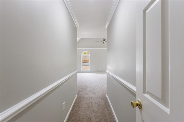 hallway with baseboards, ornamental molding, and carpet floors