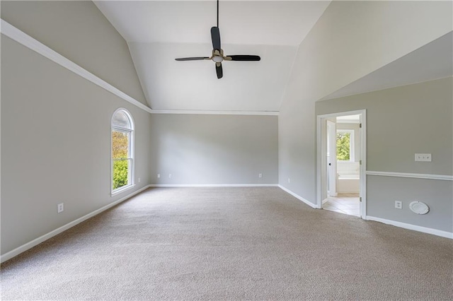 empty room featuring baseboards, high vaulted ceiling, ceiling fan, and carpet