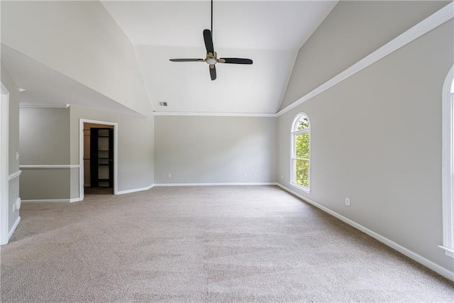 empty room with visible vents, carpet floors, baseboards, high vaulted ceiling, and a ceiling fan