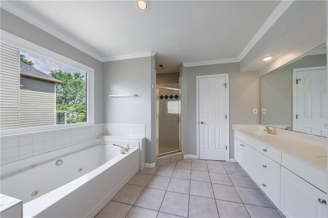 bathroom featuring a tub with jets, tile patterned flooring, a sink, a stall shower, and crown molding
