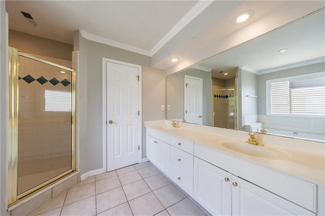 bathroom featuring a stall shower, tile patterned flooring, crown molding, and a sink