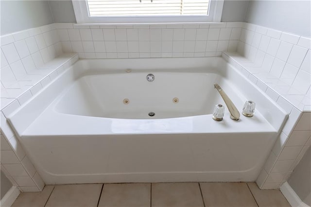 full bath featuring a tub with jets, tile patterned floors, and plenty of natural light