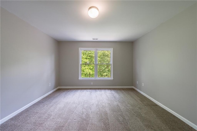 carpeted empty room with baseboards and visible vents