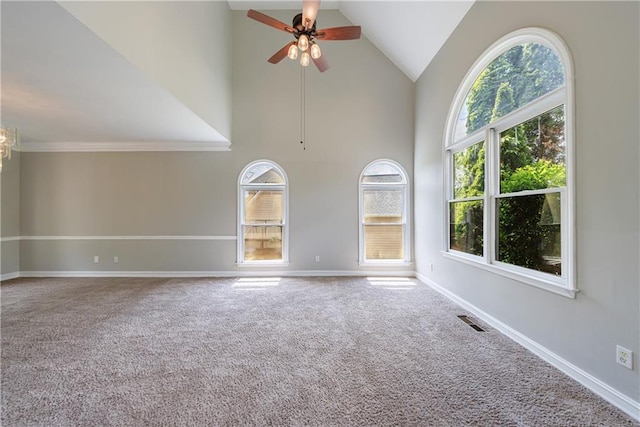 empty room with baseboards, ceiling fan with notable chandelier, and carpet floors