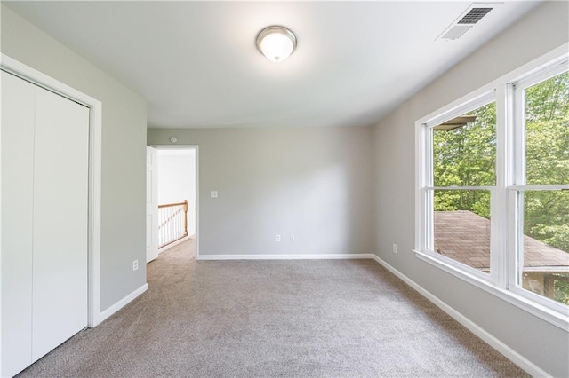 interior space featuring carpet, visible vents, and baseboards